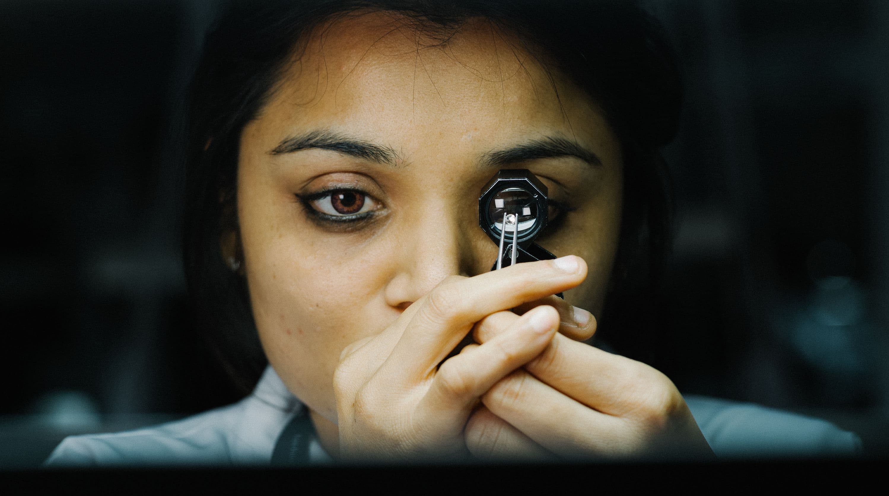 Woman examining a diamond